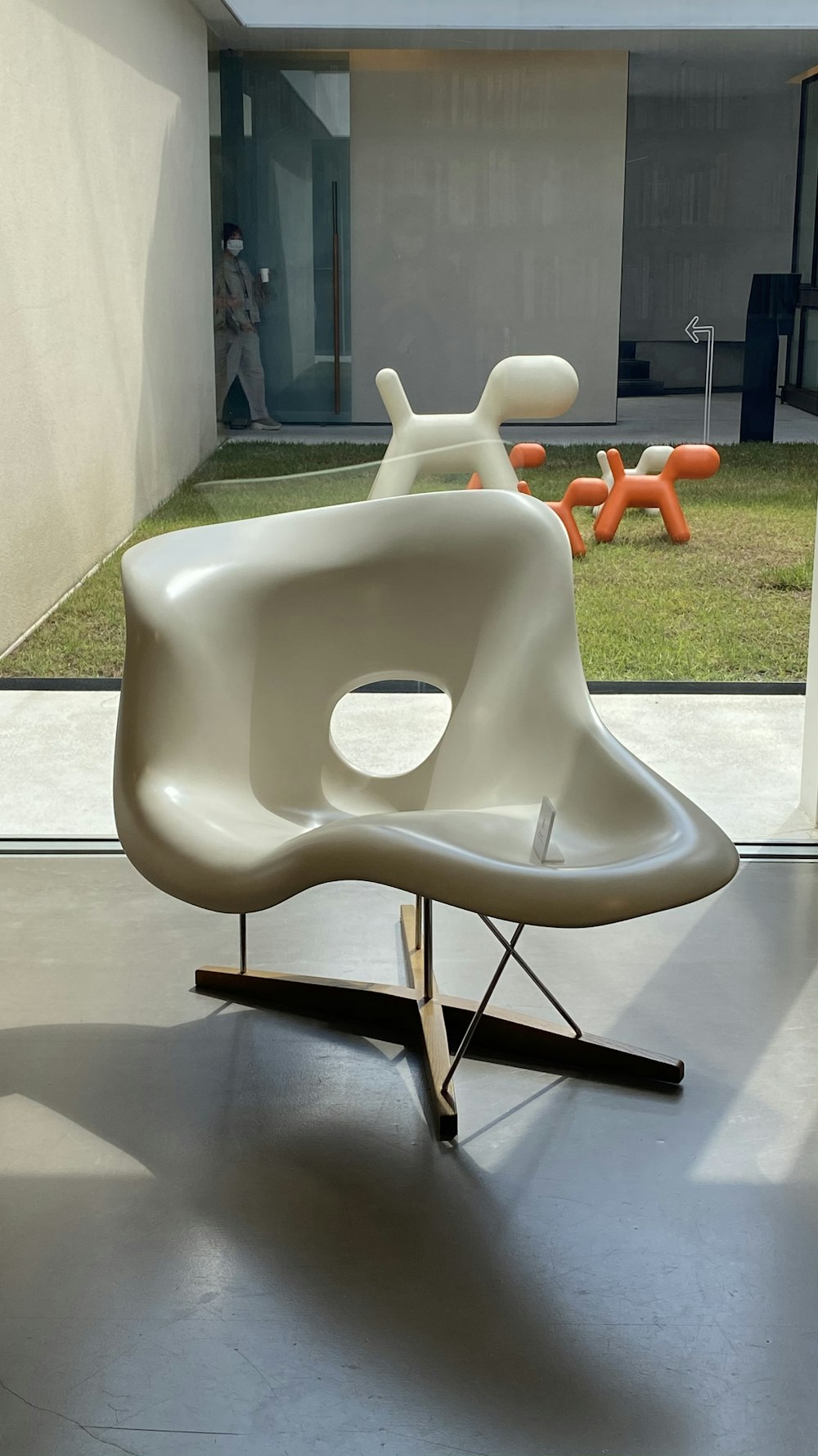 white plastic armchair on gray concrete floor