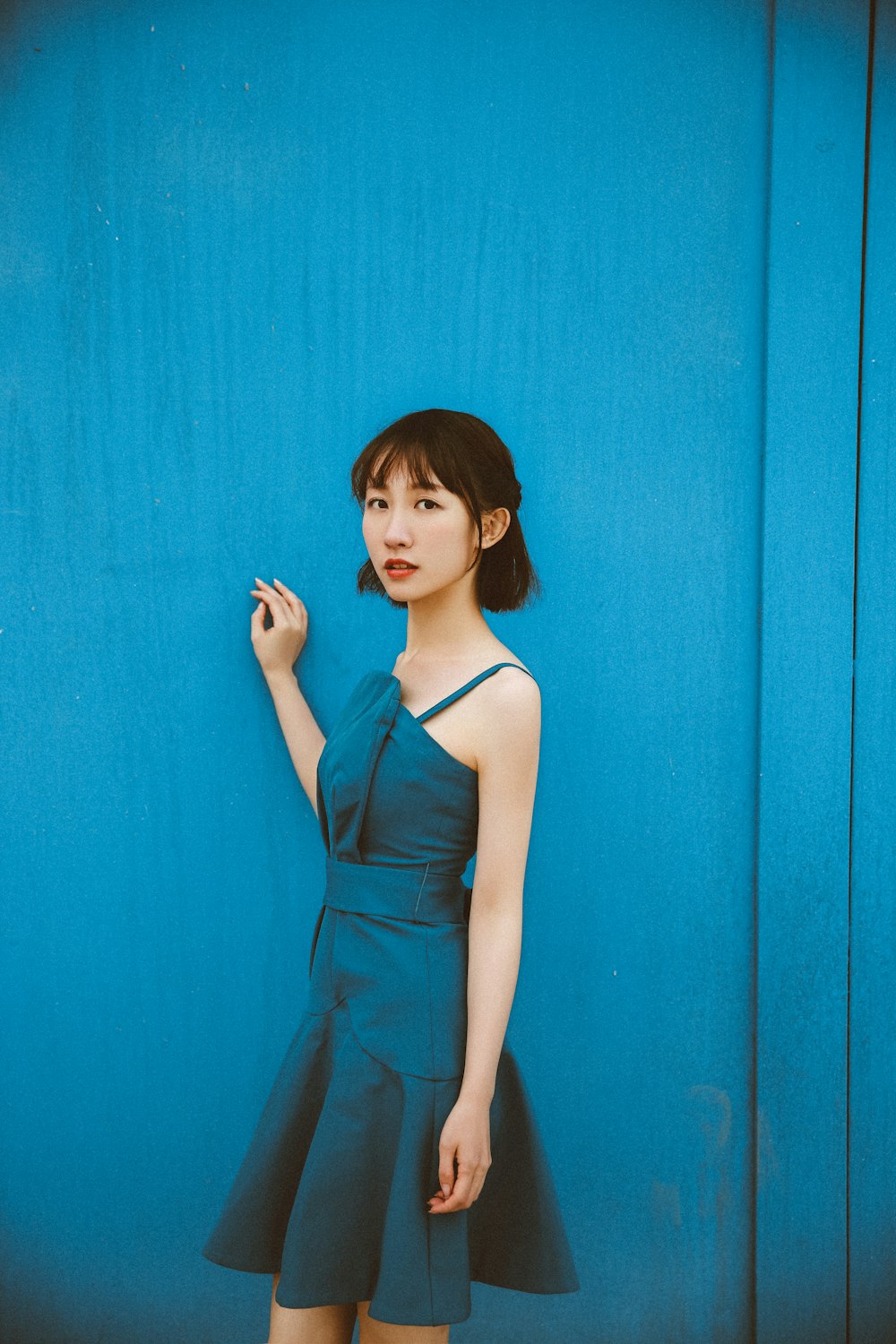 woman in blue spaghetti strap dress