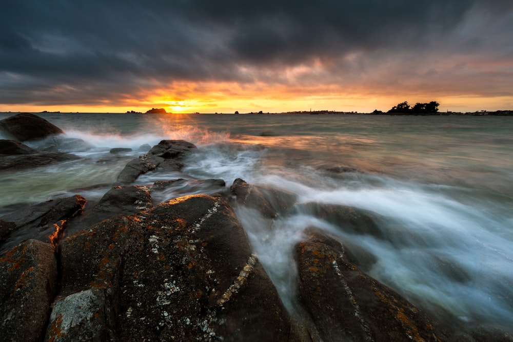 time lapse photography of water falls during sunset