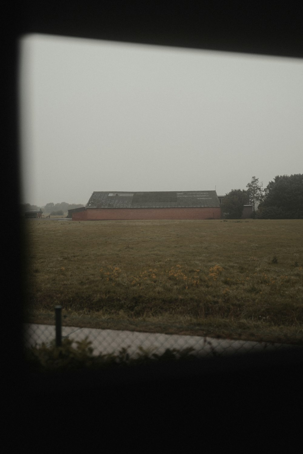 red and white concrete building on green grass field during daytime