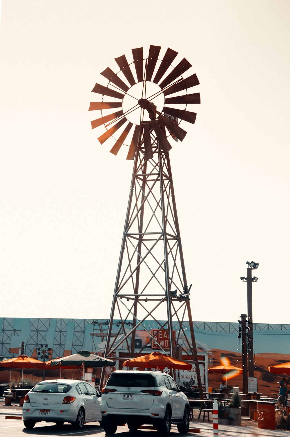 orange and white ferris wheel under white sky during daytime