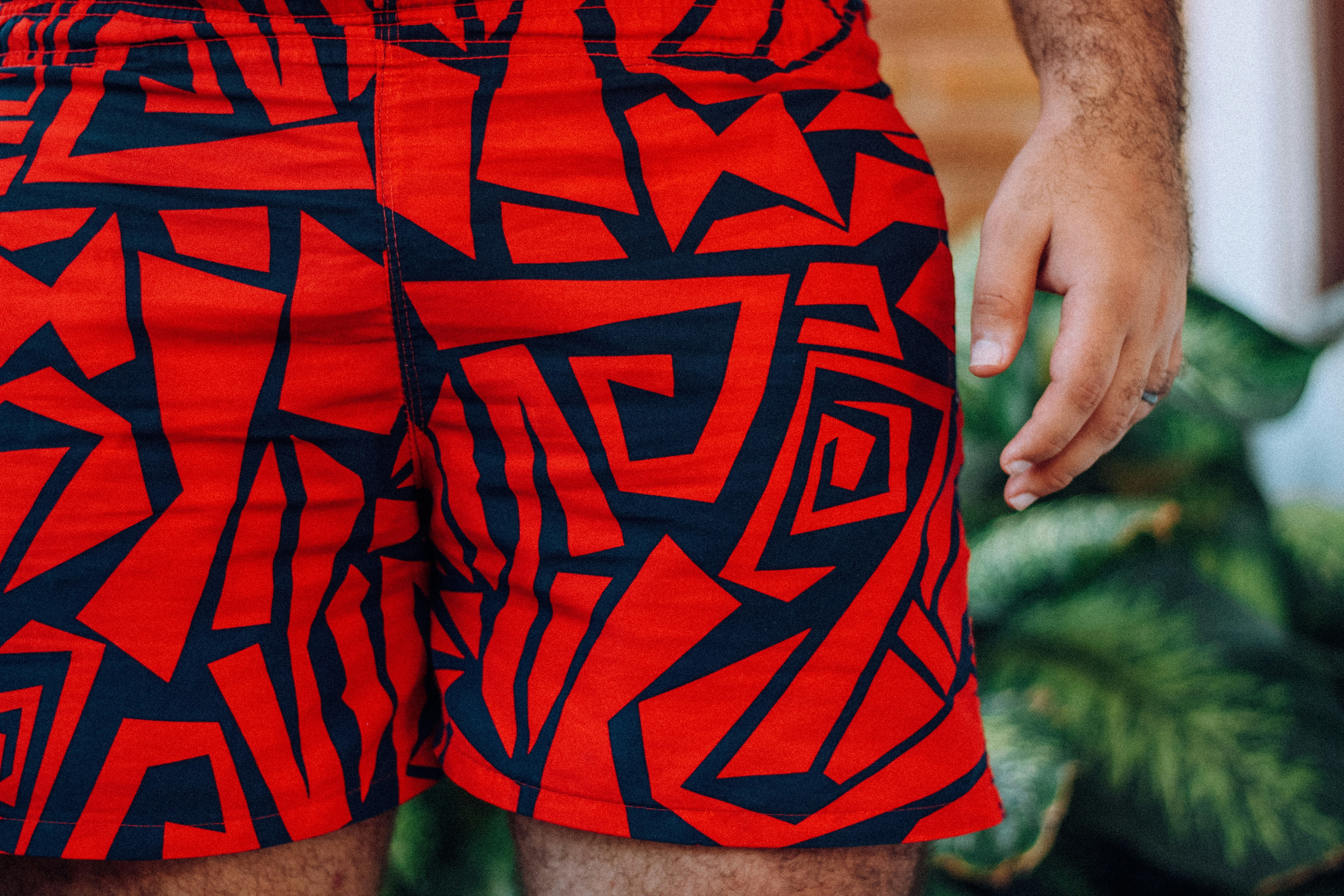 man in red and black shorts