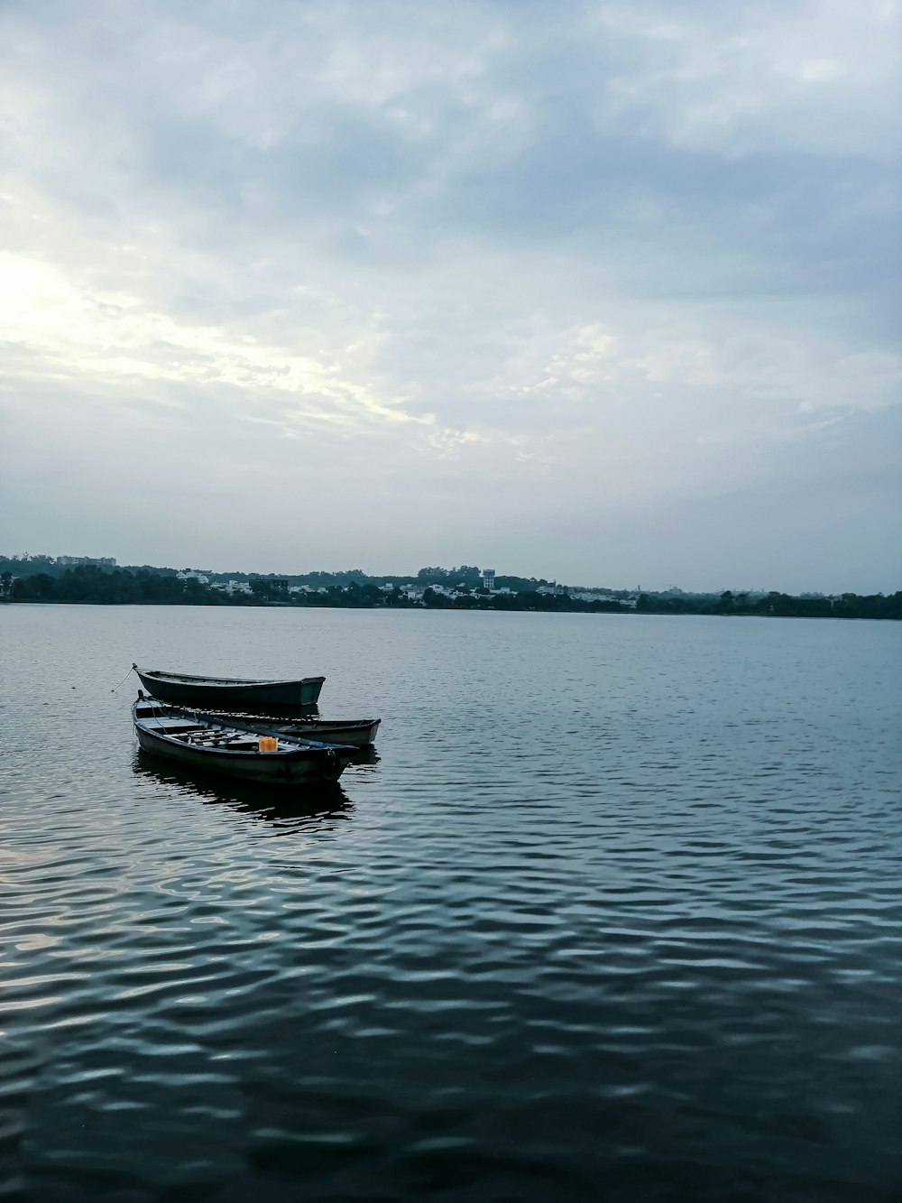 boat on water under cloudy sky during daytime