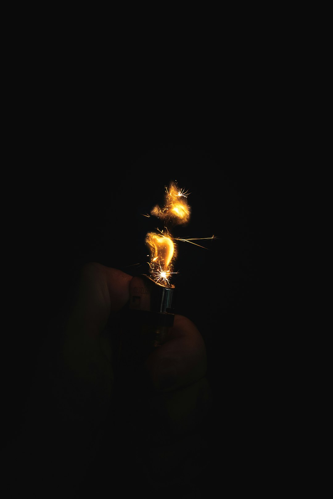 topless man holding lighter with fire