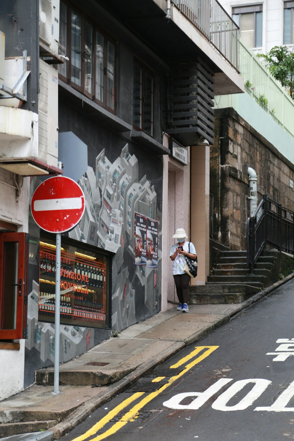 man in white jacket and black pants walking on sidewalk during daytime