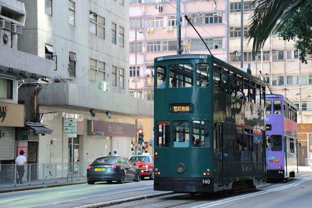 green and red tram on road during daytime