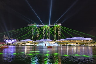 blue bridge over water during night time