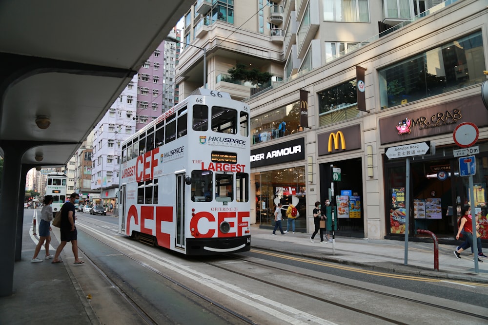 white and red tram on road during daytime