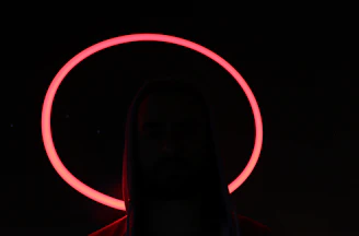 A shadowy figure lurking near a flickering neon sign in a pixel art style.