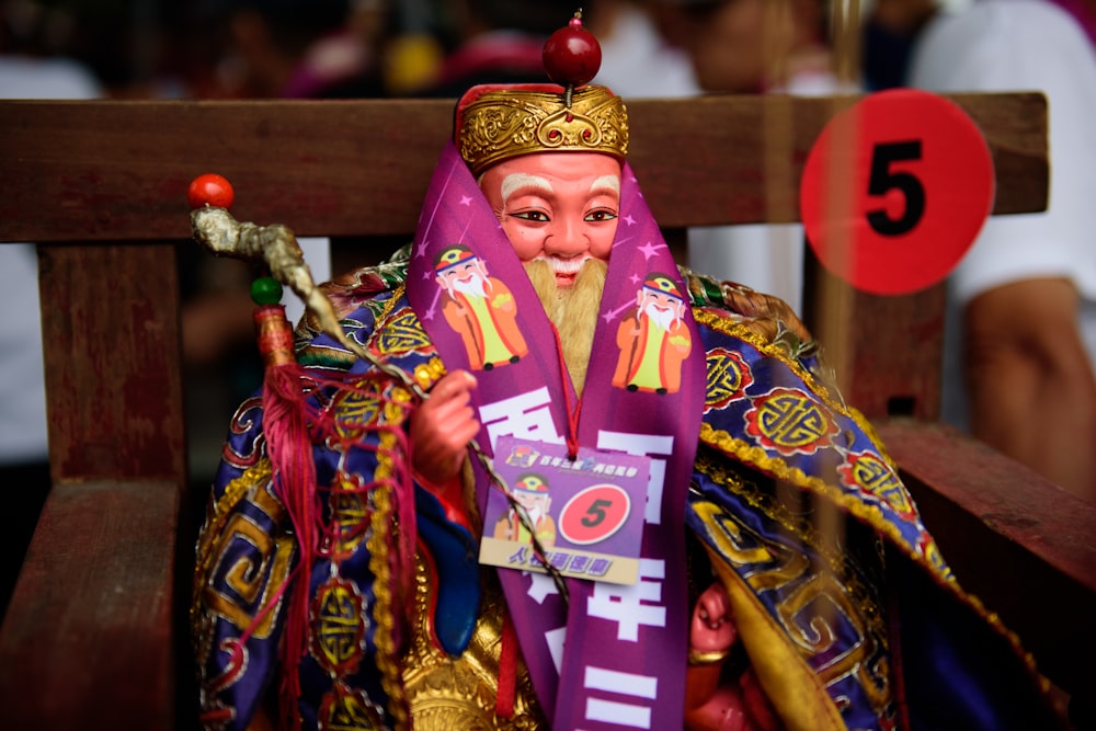 man in purple and gold traditional dress