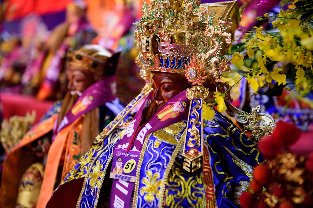 man in red and gold traditional dress