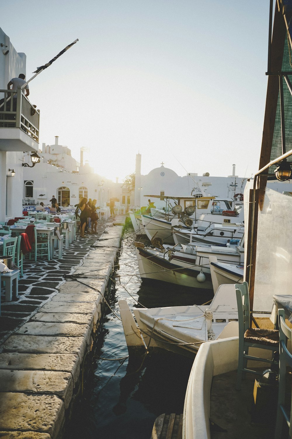 white and blue boat on dock during daytime