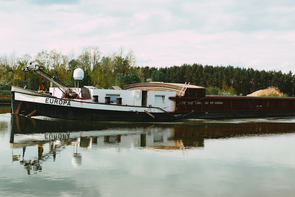 white and red boat on water