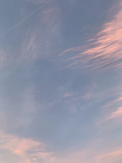 A serene sky at dawn with soft pastel colors blending gently.