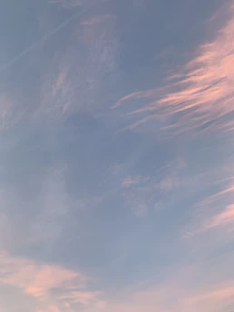 A serene sky at dawn with soft pastel colors blending gently.