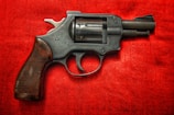 black and silver revolver on red textile
