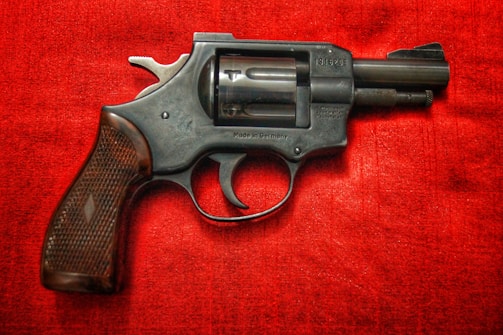 black and silver revolver on red textile