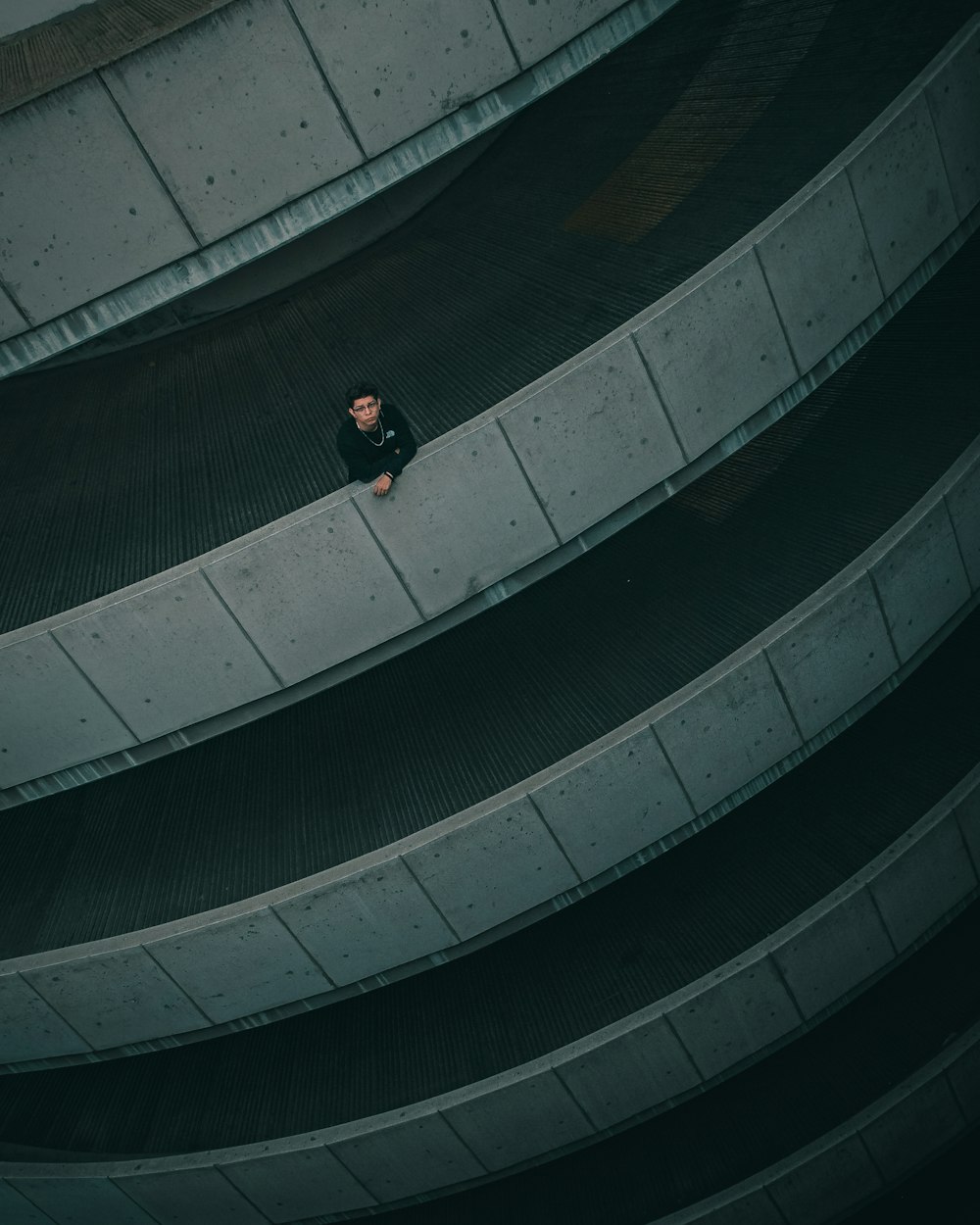 man in white shirt and black pants walking on tunnel