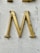 yellow wooden cross on white concrete wall