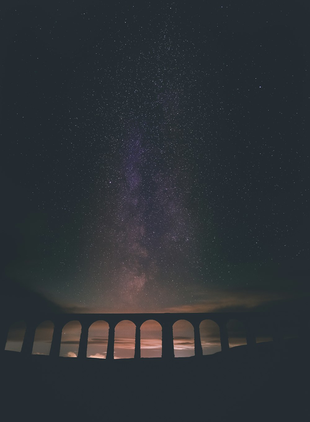 brown wooden fence under starry night