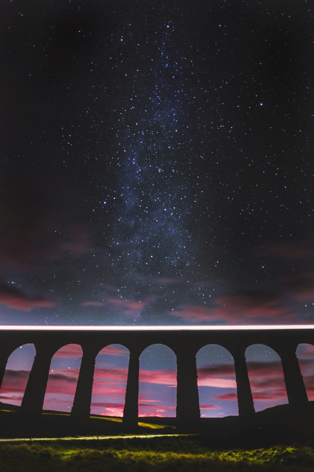 black and white bridge under starry night