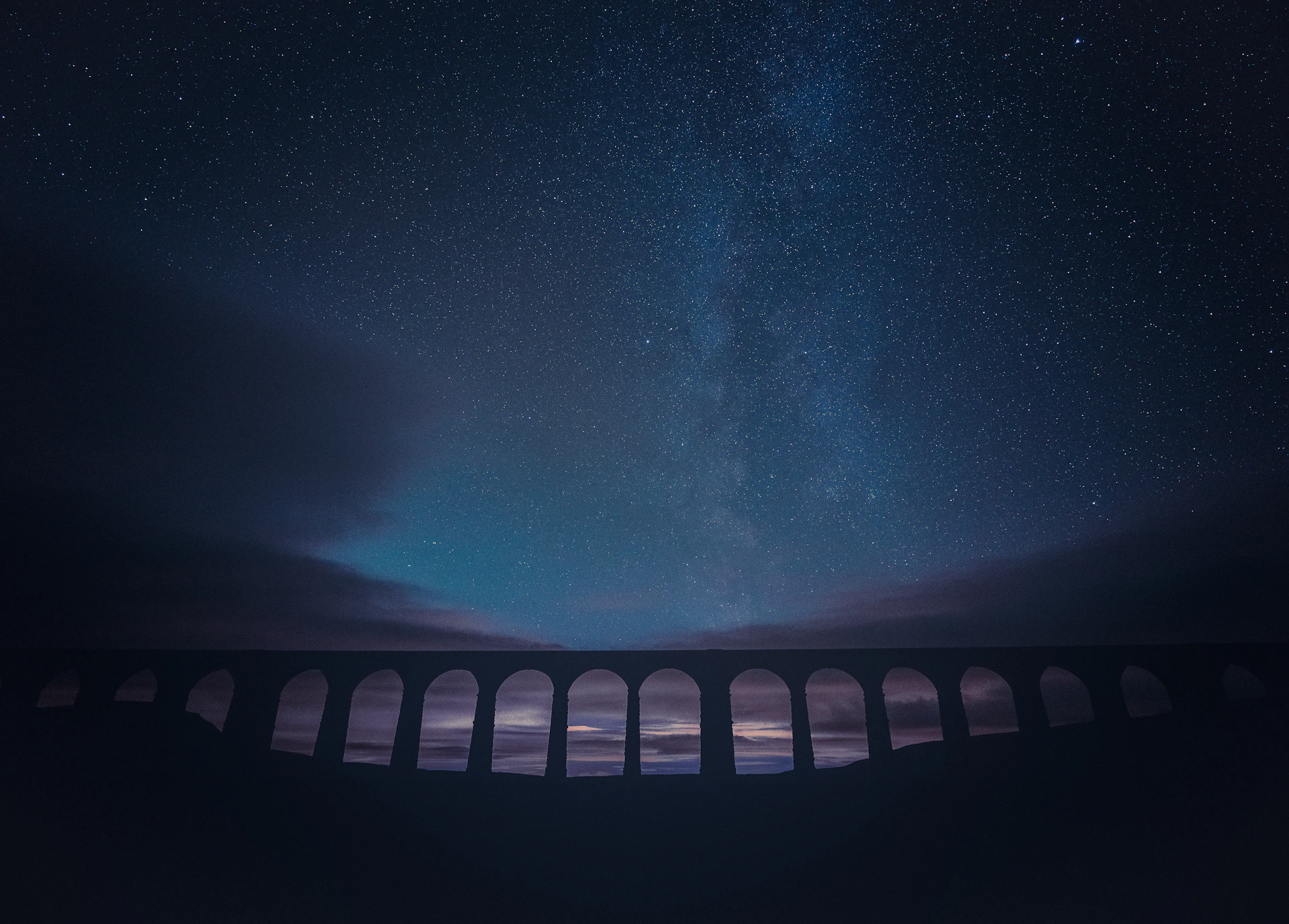 black and white bridge under starry night