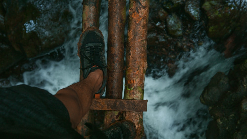 person holding brown wooden stand