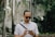 man in white button up shirt wearing black sunglasses holding black smartphone
