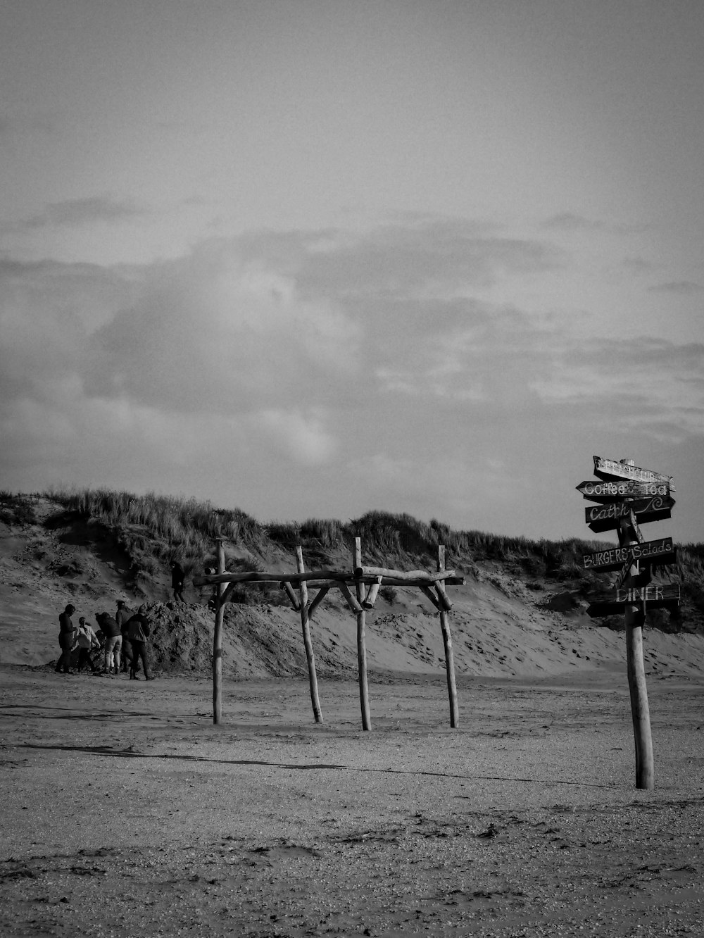 grayscale photo of people walking on road near mountain