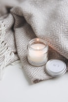 white candle on white textile