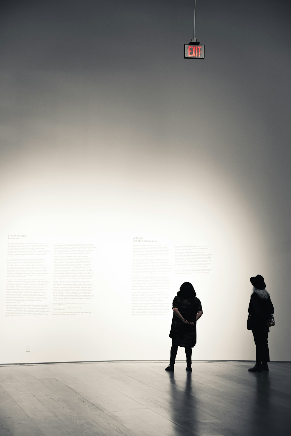 2 person standing in front of white wall