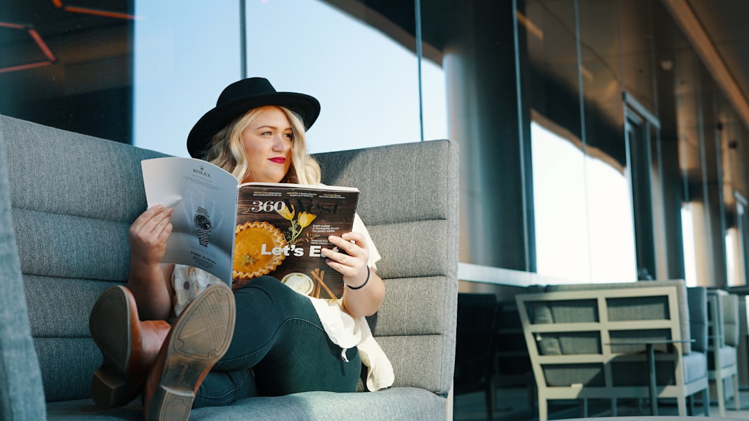 woman in blue denim jeans reading book