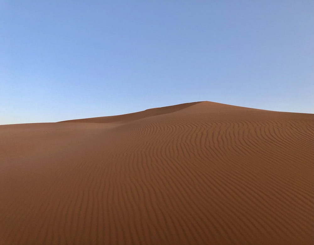 brown sand under blue sky during daytime