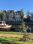 red and white boat on water near building during daytime