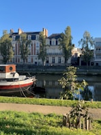 red and white boat on water near building during daytime