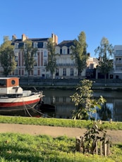red and white boat on water near building during daytime