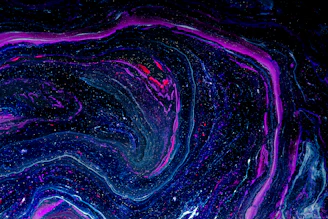 A swirling galaxy of deep indigo and amethyst hues with golden stars scattered across.