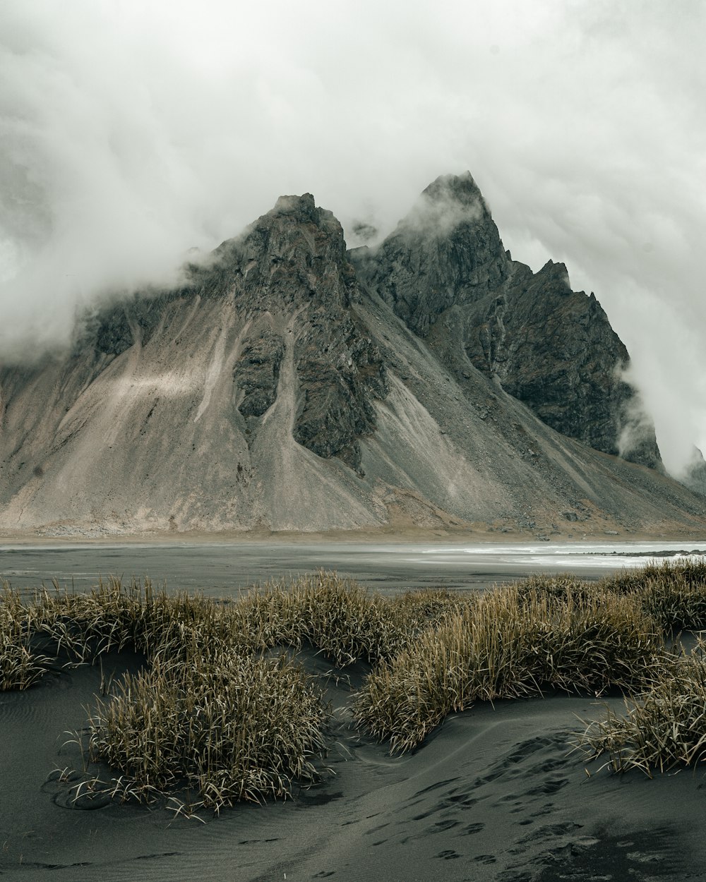 green and brown mountain under white clouds during daytime