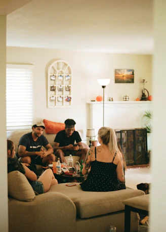 four friends chatting together on couch 
