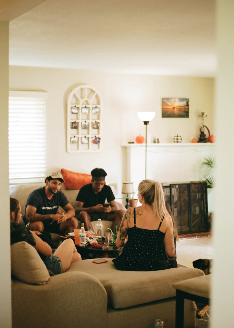 four friends chatting together on couch 