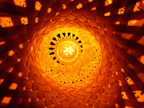Handwoven fiber art piece glowing gently in natural light