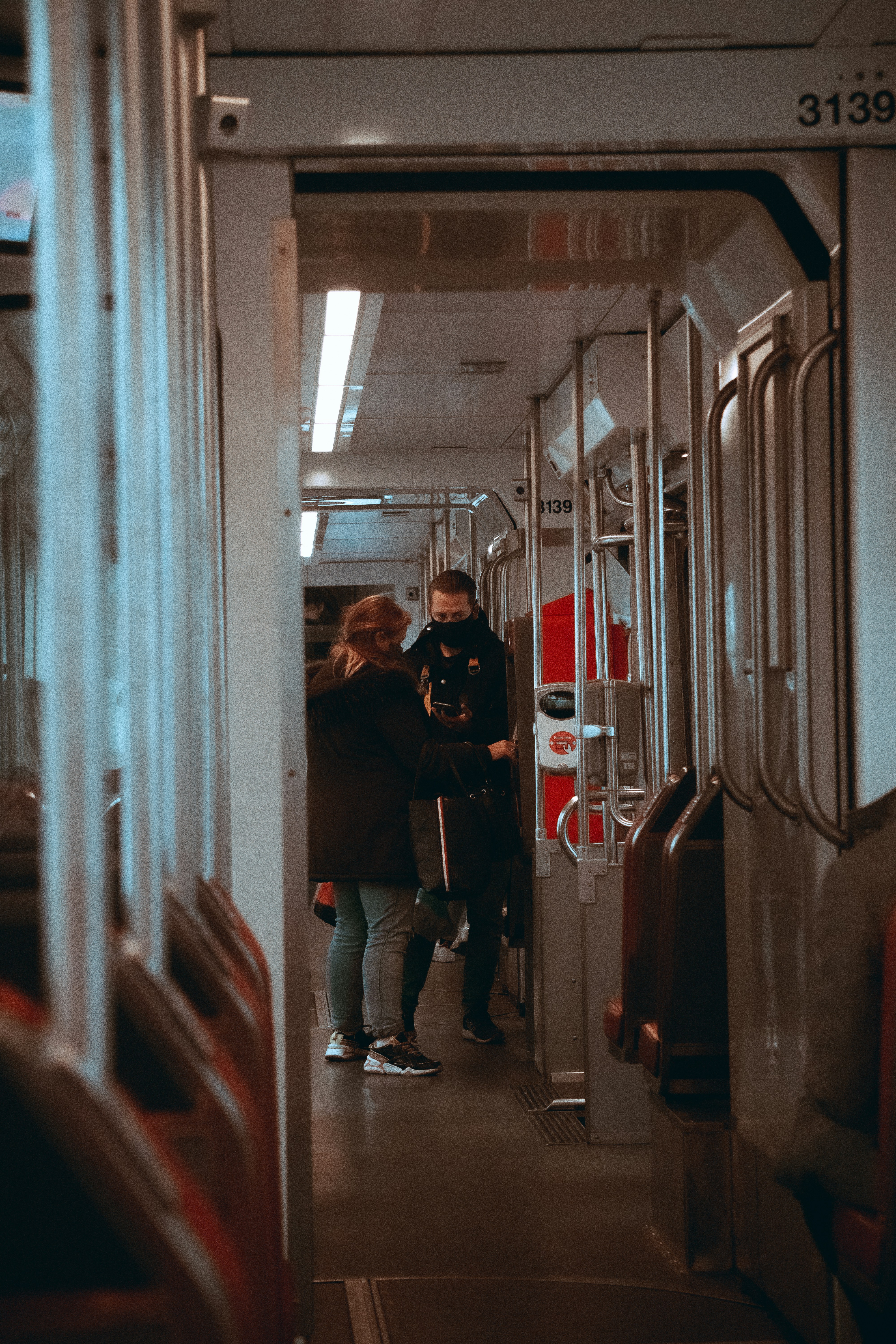 man in black jacket standing in front of mirror
