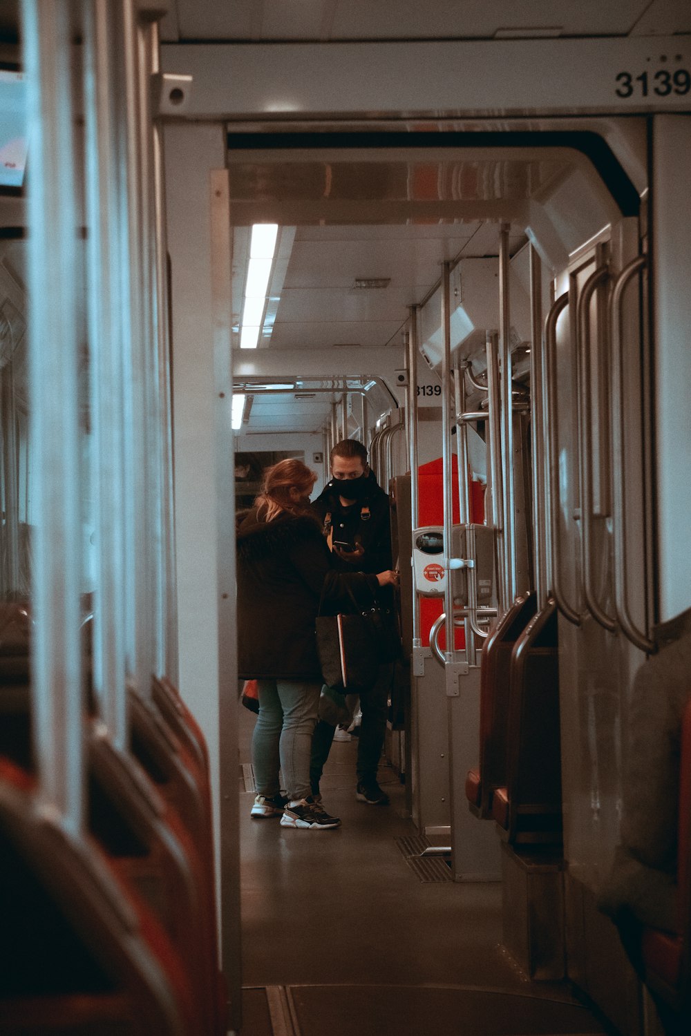 man in black jacket standing in front of mirror