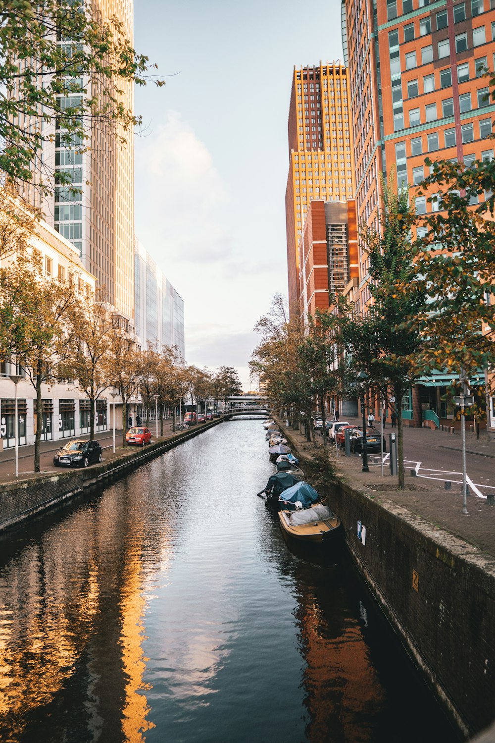 people riding on boat on river near high rise buildings during daytime