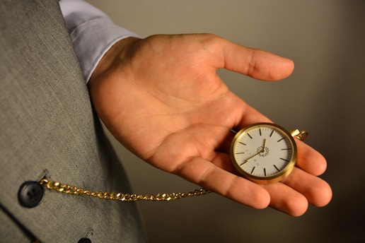 gold and silver round analog watch