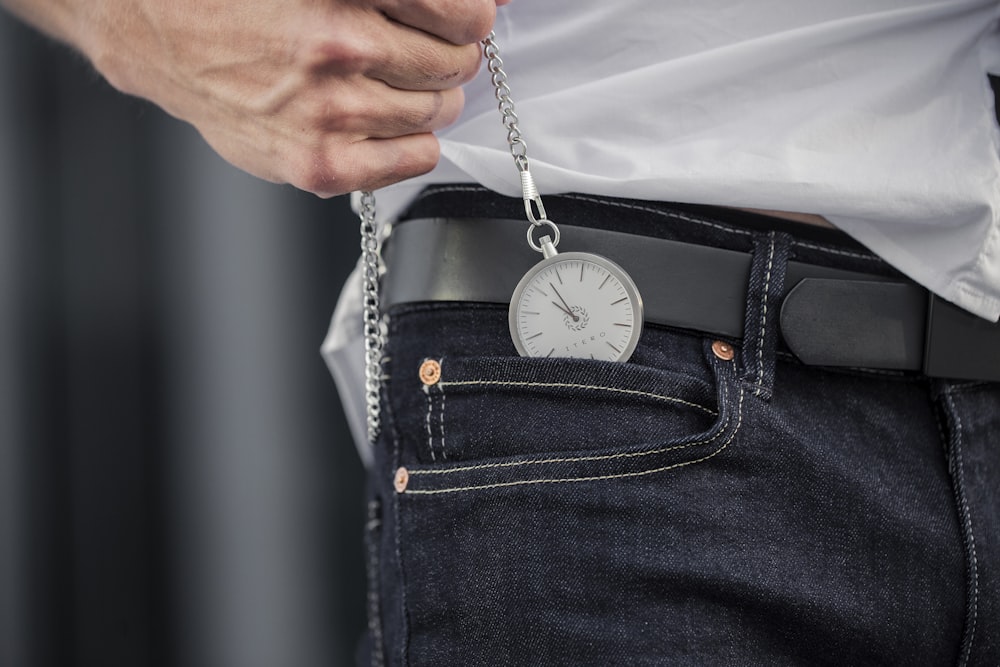 person in blue denim jeans with silver and white pocket watch photo – Free  Vienna Image on Unsplash