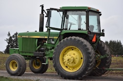 green tractor on brown soil