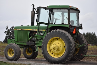 green tractor on brown soil