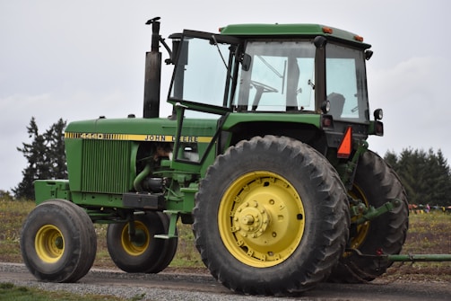 green tractor on brown soil