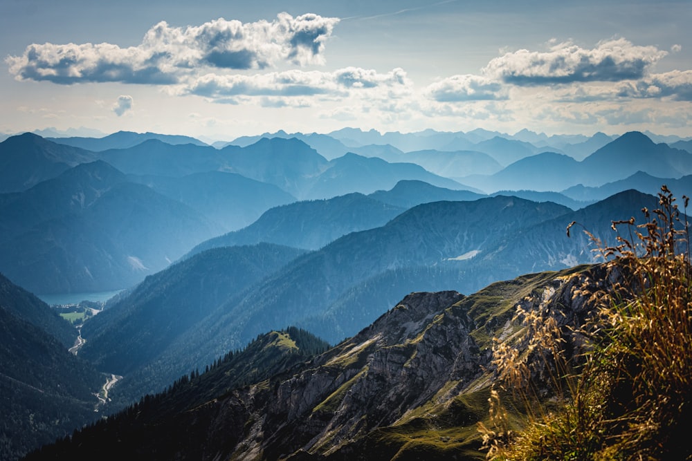 green and brown mountains under white clouds and blue sky during daytime